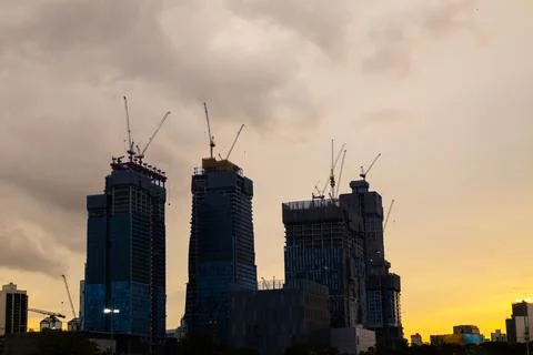 About the tower crane at the construction site event evening looking from bel Stock Photos