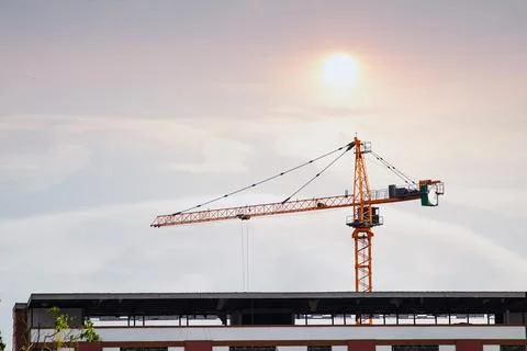 About the tower crane at some of the construction sites when sunset that is.. Stock Photos