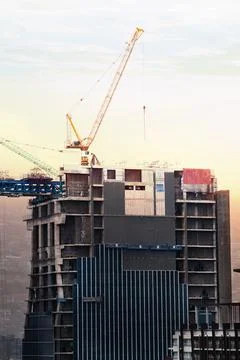 About the tower crane at some of the construction sites when sunset that is.. Stock Photos