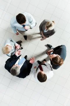Above angle of several smart associates talking to each other at meeting Stock Photos