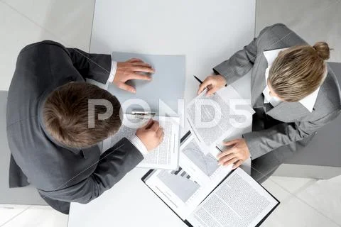 Above angle of two business partners planning work at meeting Stock Photos
