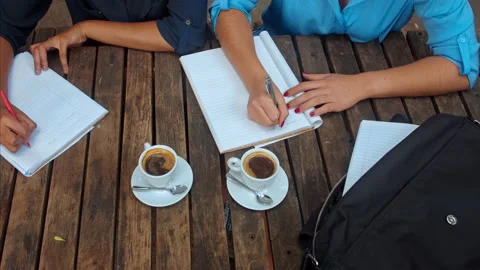 Above angle view of casual entrepreneur woman team/student team, writing down th Stock-Footage 199633335