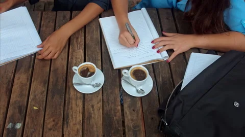 Above angle view of casual entrepreneur woman team/student team, writing down th Stock-Footage 199633365