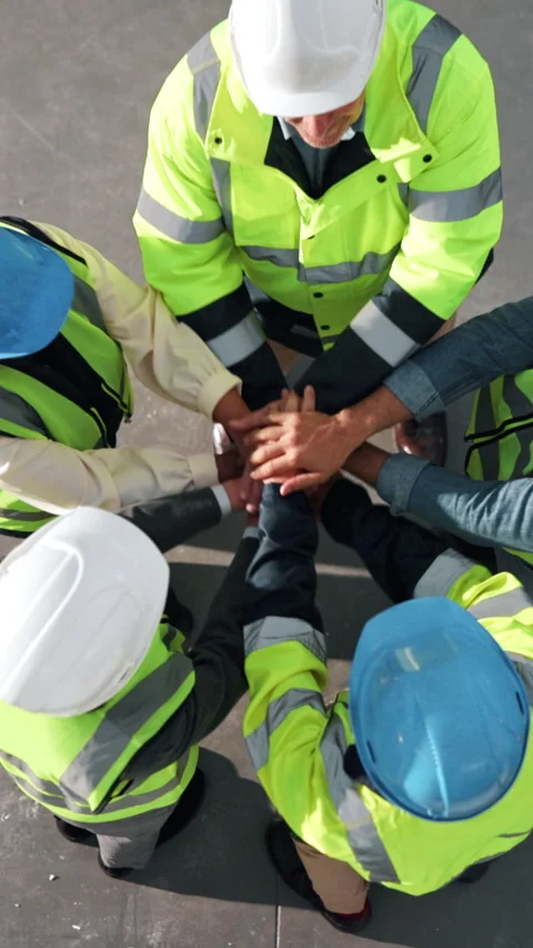 Above, applause and construction team with stack of hands on site for Stock Footage 342323792
