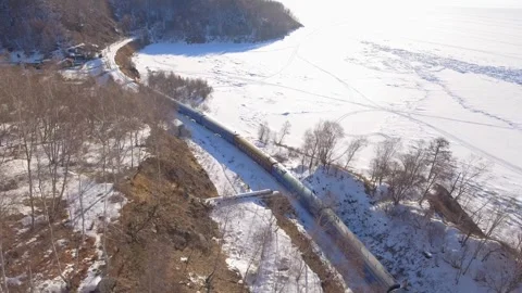 From above authentic old train on winter railway journey, frozen Lake Baikal 4k Stock Footage 317963755