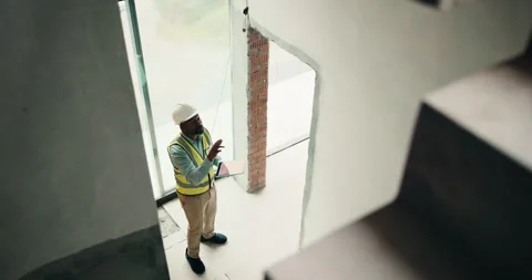 Above, black man and construction worker with tablet on site for feedback on Vídeos de archivo 337863522