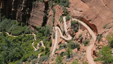 Above a canyon trail zig-zagging up a cliff in Zion National Park. Stock Footage 128777705