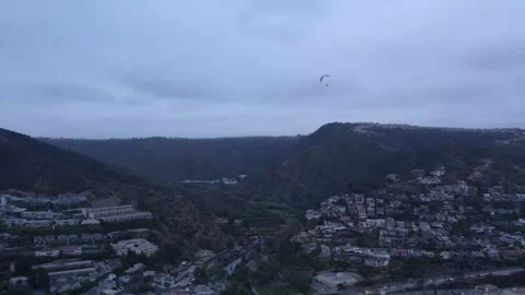 Above the Canyons: Paragliders Over Hillside Enclaves Stock Footage 305647780