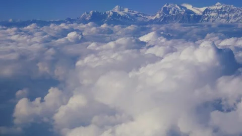 Above the clouds and mountains, a view from airplane Stock Footage 245636842