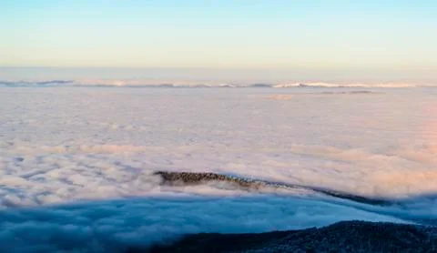 Above the clouds in dusk Stock Photos