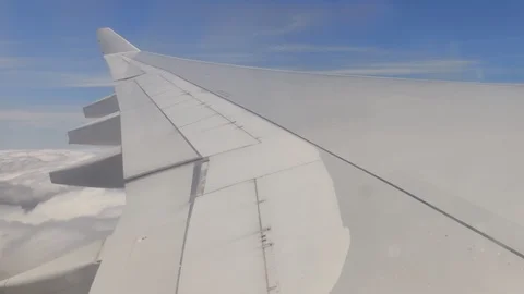 Above the clouds - Plane flying through cloudy sky window perspective Stock Footage 122662680