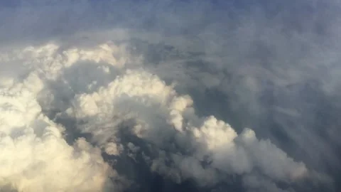 Above the clouds at sunset Flying over the clouds. View from the airplane window Stock Footage 130276561