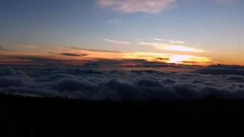 Above the clouds sunset in a mountainous area blanket of clouds Stock Footage 197406194