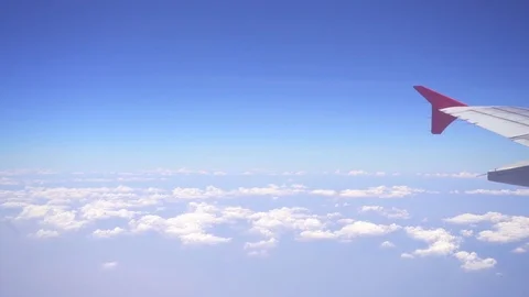 Above clouds view through an airplane window Stock Footage 80808557