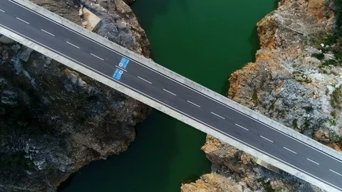 Above copter view. Moving up. The bridge crossing beautiful Dim River and green Stock Footage 86530345