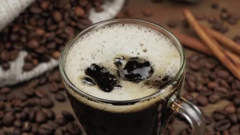 From above cube of sugar falling into glass mug of cappuccino Stock Footage 146869274