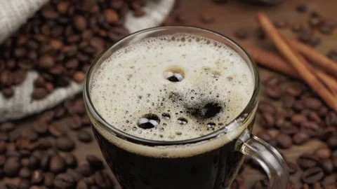 From above cube of sugar falling into glass mug of cappuccino Stock Footage 146869277
