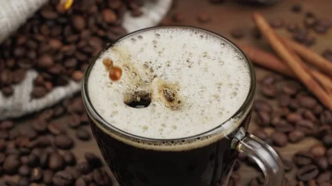 From above cube of sugar falling into glass mug of cappuccino Stock Footage 146869279