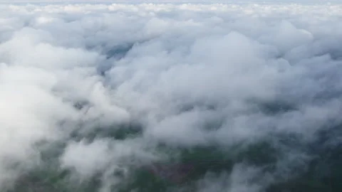 Above the dense clouds covering the countryside. Stock Footage 162599596