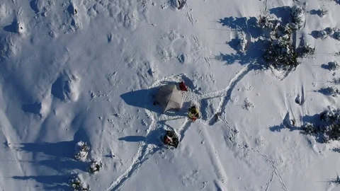 Above drone-footage of two persons camping in the snow (original) Stock Footage 84036315