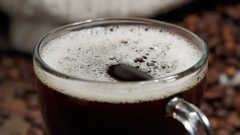 From above drop falling into cup of freshly brewed coffee with bubbles on table Stock Footage 146869311