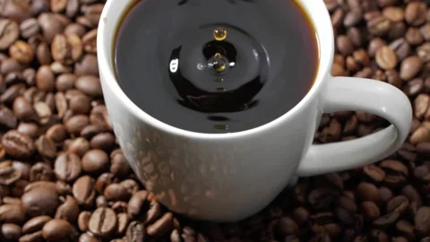 From above drop falling into white cup of freshly brewed fragrant black coffee Stock Footage 146921747