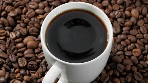 From above drop falling into white cup of freshly brewed fragrant black coffee Stock Footage 146921764