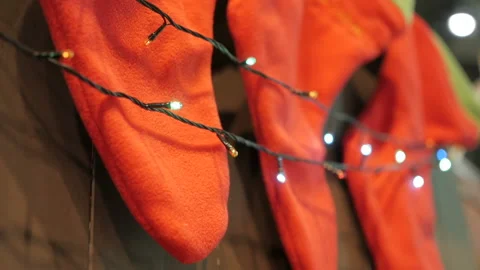 Above the fireplace hangs a burning socks for gifts for Christmas Stock Footage 99641026