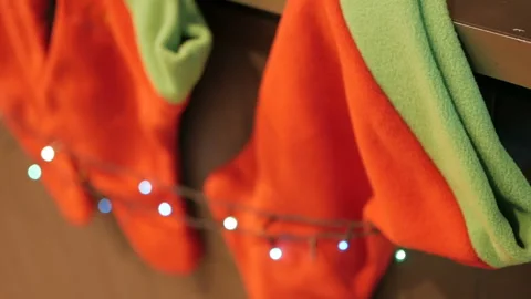 Above the fireplace hangs a burning socks for gifts for Christmas Video stock 99642143