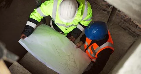 Above, floorplan and engineer team on construction site for planning, renov.. Stock Photos