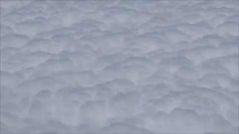 Above fluffy white clouds texture background video view from aircraft Stock Footage 282764487