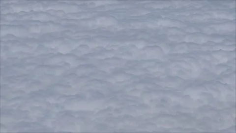 Above fluffy white clouds texture background video view from aircraft Stock Footage 282764506