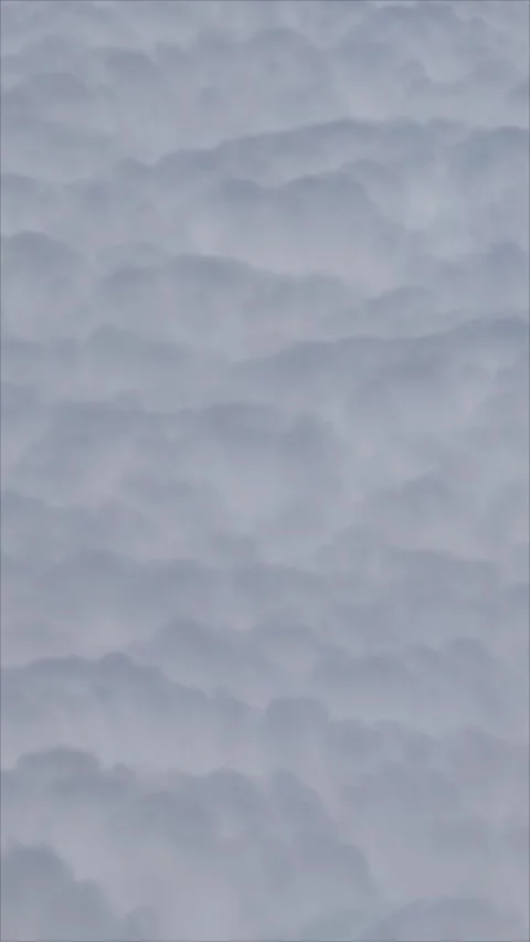 Above fluffy white clouds vertical background video view from flying aircraft Stock Footage 282764476