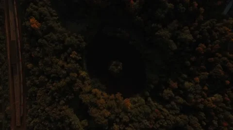 Above forest trees around small lake with on shore at autumn day Stock Footage 55358965