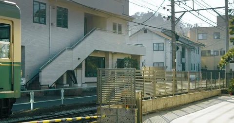 Above Ground Train Passing by in the City of Kamakura, Japan Stock Footage 125713664