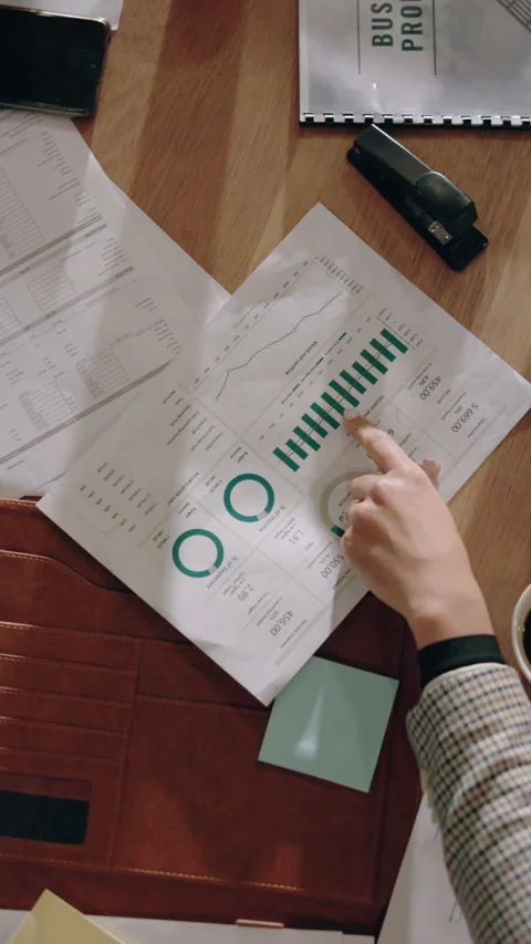 Above, hands and data analysis in meeting with documents, cashflow report and Stock Footage 338055108