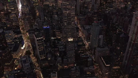 Above lit up parallel avenues and junctions, residential condominiums and office Stock Footage 147366133