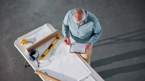 Above, man and engineer with clipboard for construction, survey and inspection Stock Footage 341548456