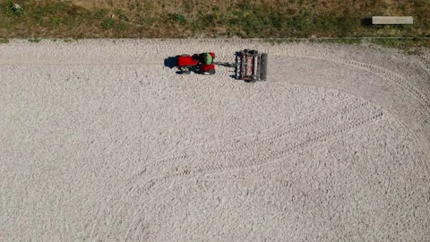 From above a man driving an equestrian implement, mixing and smooth the Stock Footage 239399154