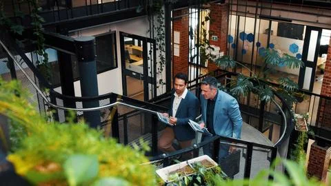 Above, manager and man with tablet on steps for financial forecasting with Stock Photos