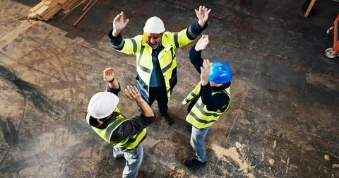 Above, men and construction workers with celebration on site for building, .. Stock Photos