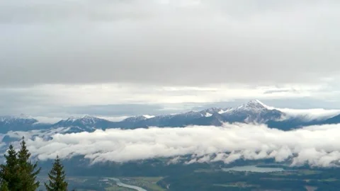 From above to the mountains and thick white clouds covered with Stock Footage 254150134