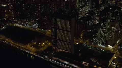 Above New York's East River at night, UN Building in foreground. Shot in Stock Footage 59171802