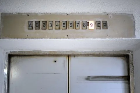 Above old elevator door light display with number nine floor. Interior of the Stock Photos