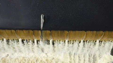 Above of an over-flow dam after a rain storm - look-down gentle-rise aerial Stock Footage 161264449