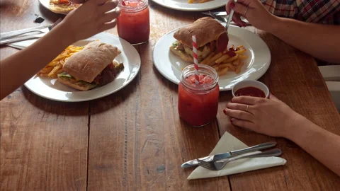 Above panning view of a young multicultural group of friends, sharing a meal/eat Stock Footage 199633511