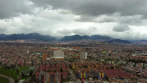 From above, the patchwork of vibrant buildings, winding roads, and lush Stock Footage 270273302