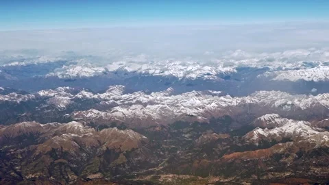 Above the peaks a clouds covers the sky, snow capped Alps rugged mountain peaks. Stock Footage 313949748