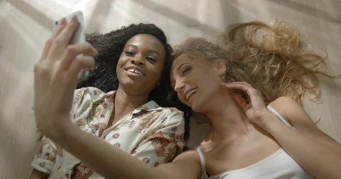 Above portrait of two multi-ethnic brunette and blonde girl friends with natural Stock Footage 86358008