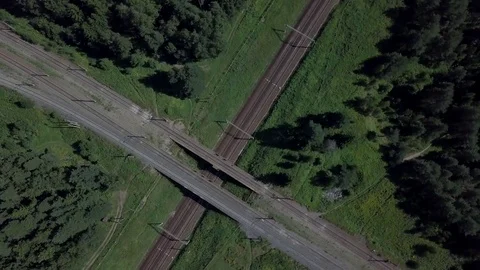 Above a railways cross, train is approaching 스톡 동영상 79670766